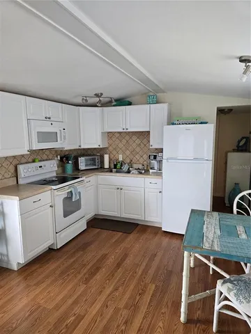 a white refrigerator freezer sitting in a kitchen