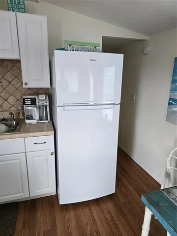 a white toilet sitting next to a shower curtain