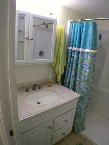 a room with painting on the wall and a potted plant