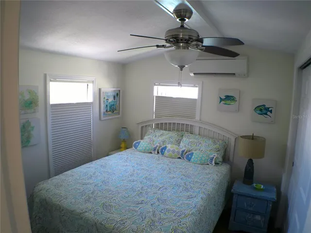 a view of a hallway with wooden floor and stairs