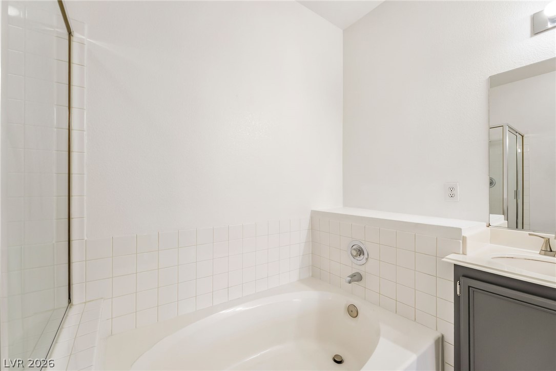 2201 Ramsgate Drive, Unit 811 Henderson, NV 89074 - Photo 27 of 36 Indulge in a tranquil soak within this well-appointed bathroom's built-in tub.