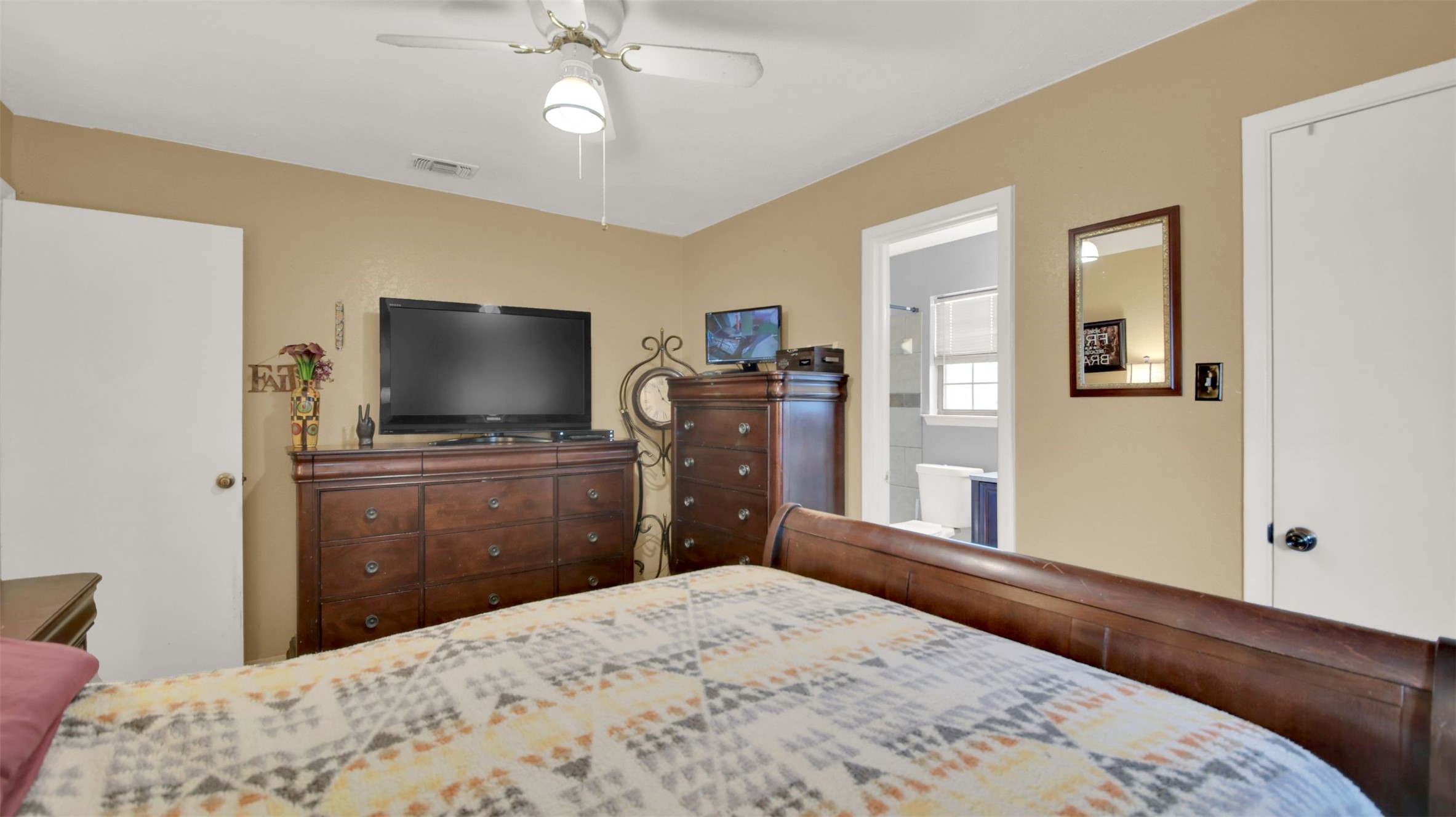 1713 Parkside Circle Round Rock, TX 78664 - Photo 11 of 18 a bedroom with a bed and a flat screen tv