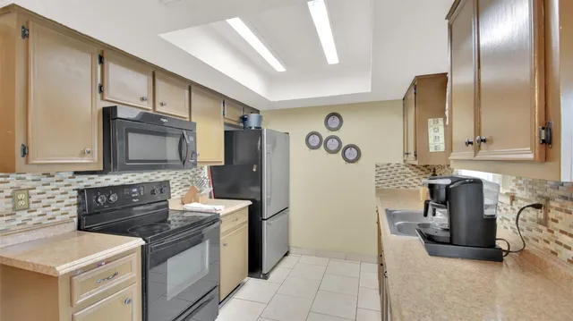 a kitchen with stainless steel appliances granite countertop a stove and a refrigerator