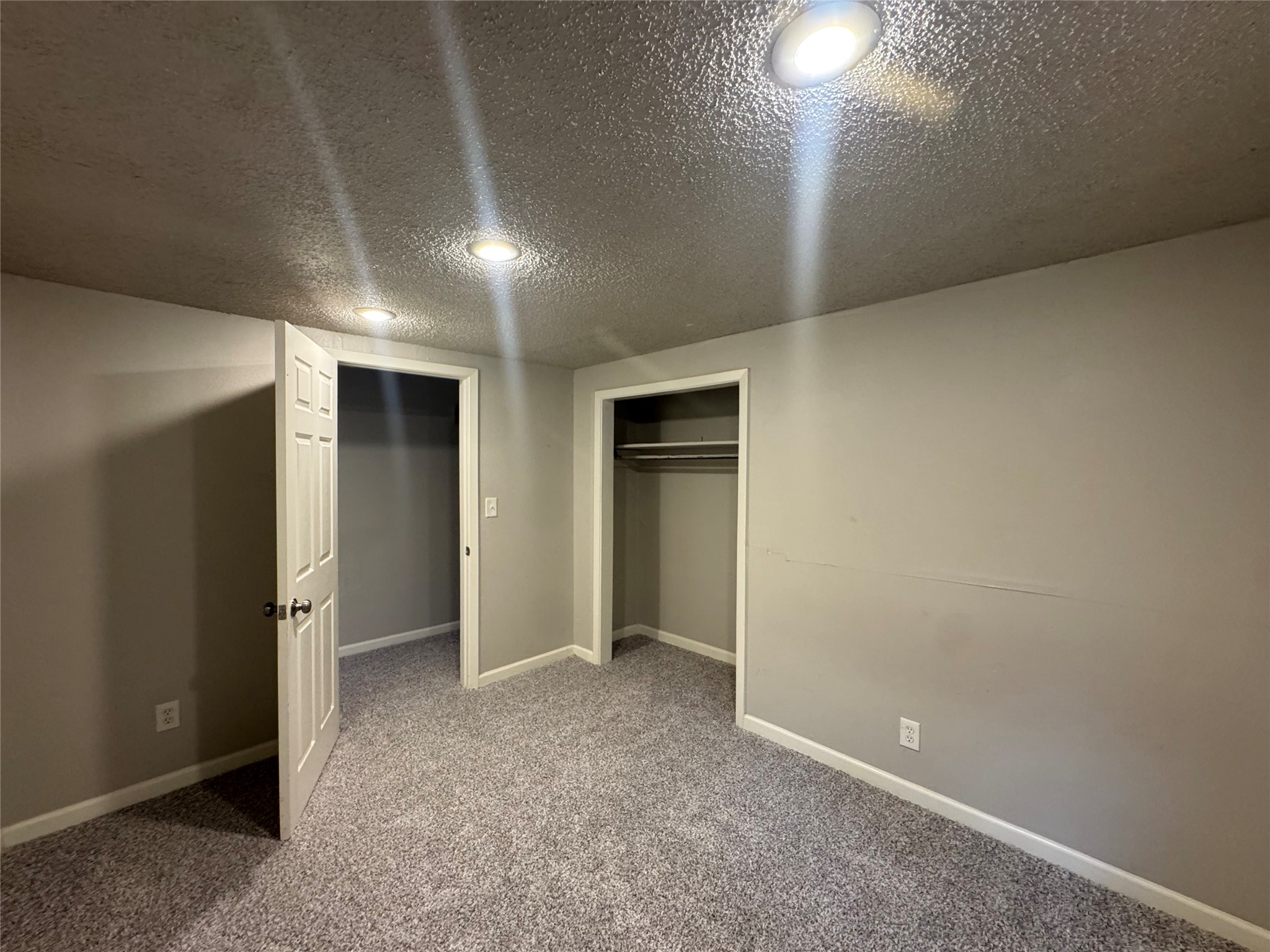 5007 Heflin Lane Austin, TX 78721 - Photo 17 of 25 A well-lit bedroom offering ample closet space and plush carpeting.