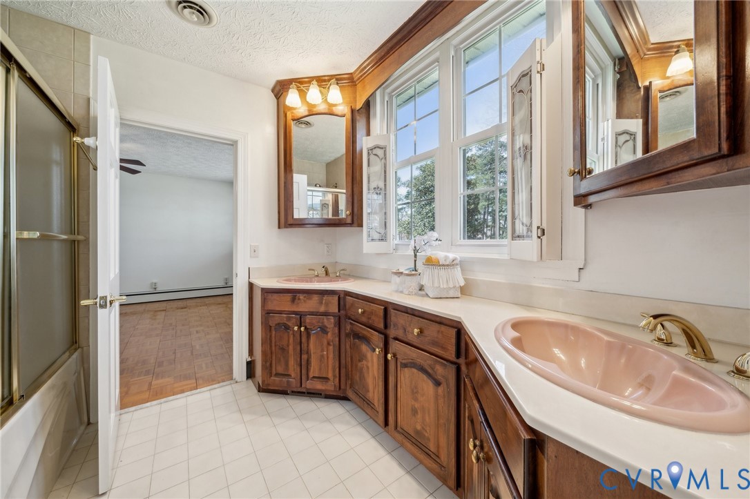 4411 Courthouse Road Prince George, VA 23875 - Photo 18 of 38 a bathroom with a tub sink and mirror