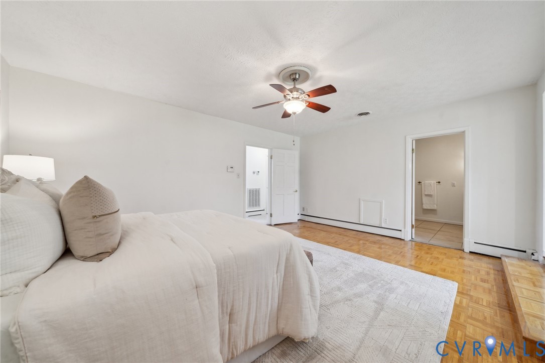 4411 Courthouse Road Prince George, VA 23875 - Photo 22 of 38 a bedroom with a bed and a chandelier