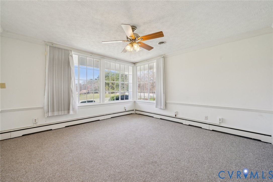 4411 Courthouse Road Prince George, VA 23875 - Photo 26 of 38 an empty room with a window and a ceiling fan