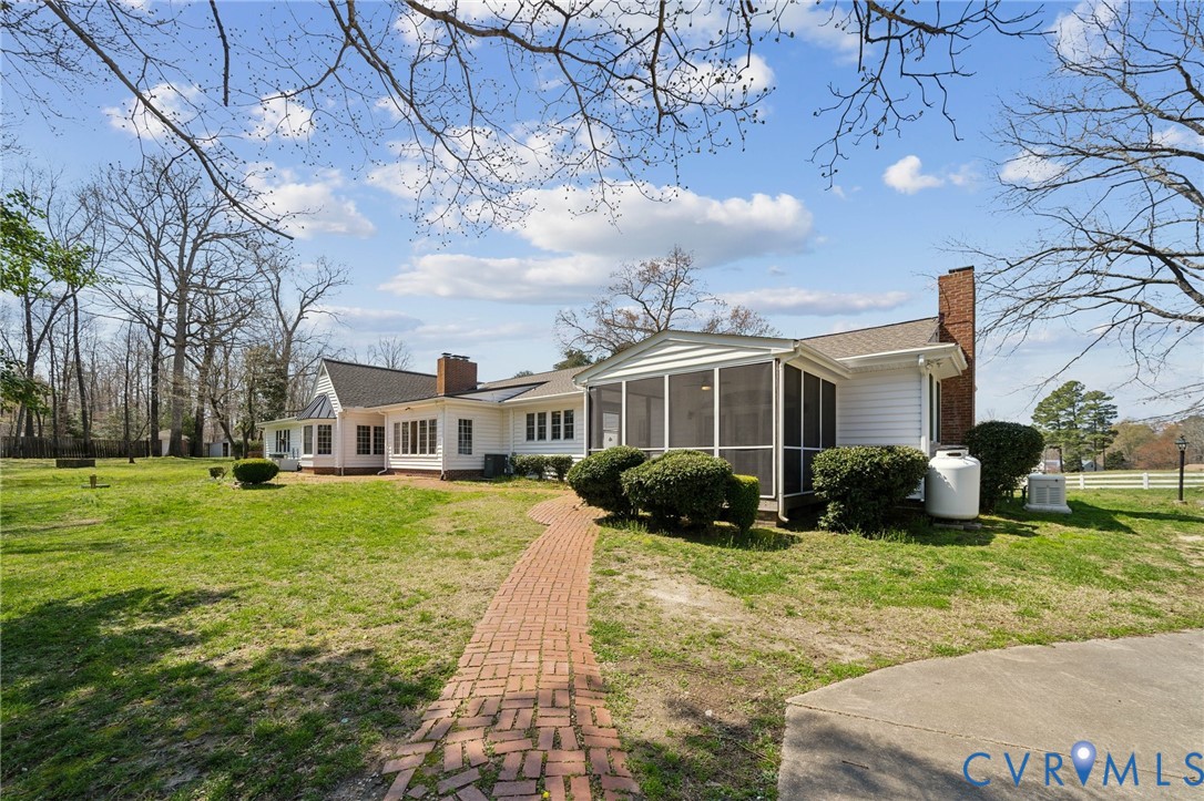 4411 Courthouse Road Prince George, VA 23875 - Photo 30 of 38 a front view of a house with a yard table and chairs