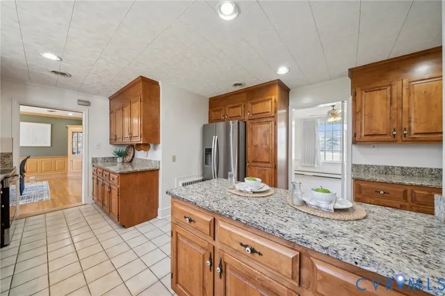 a spacious bathroom with a granite countertop sink and a mirror