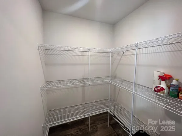 a view of storage and utility room with racks on the wall