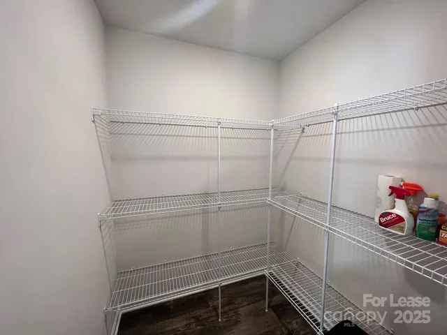 a view of storage and utility room with racks on the wall