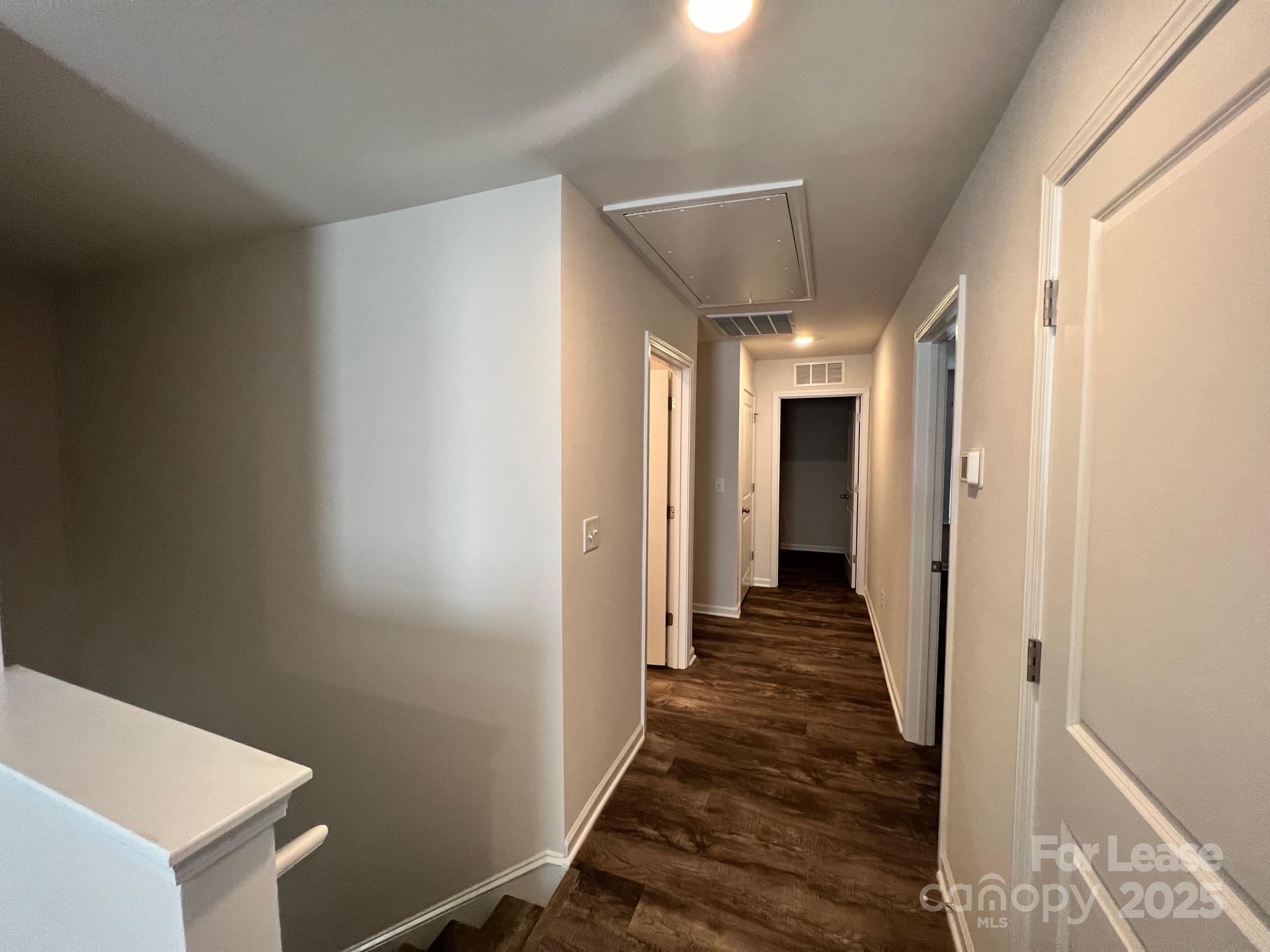 7868 Whispering Stream Drive Sherrills Ford, NC 28673 - Photo 17 of 35 a view of a hallway with wooden floor and staircase