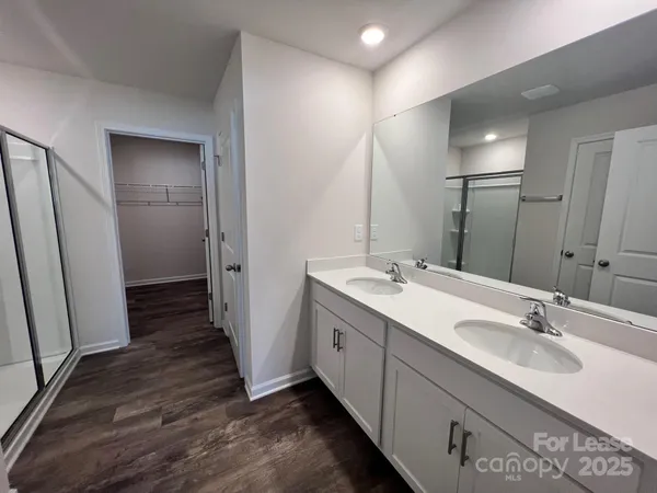 a bathroom with a shower and a glass door