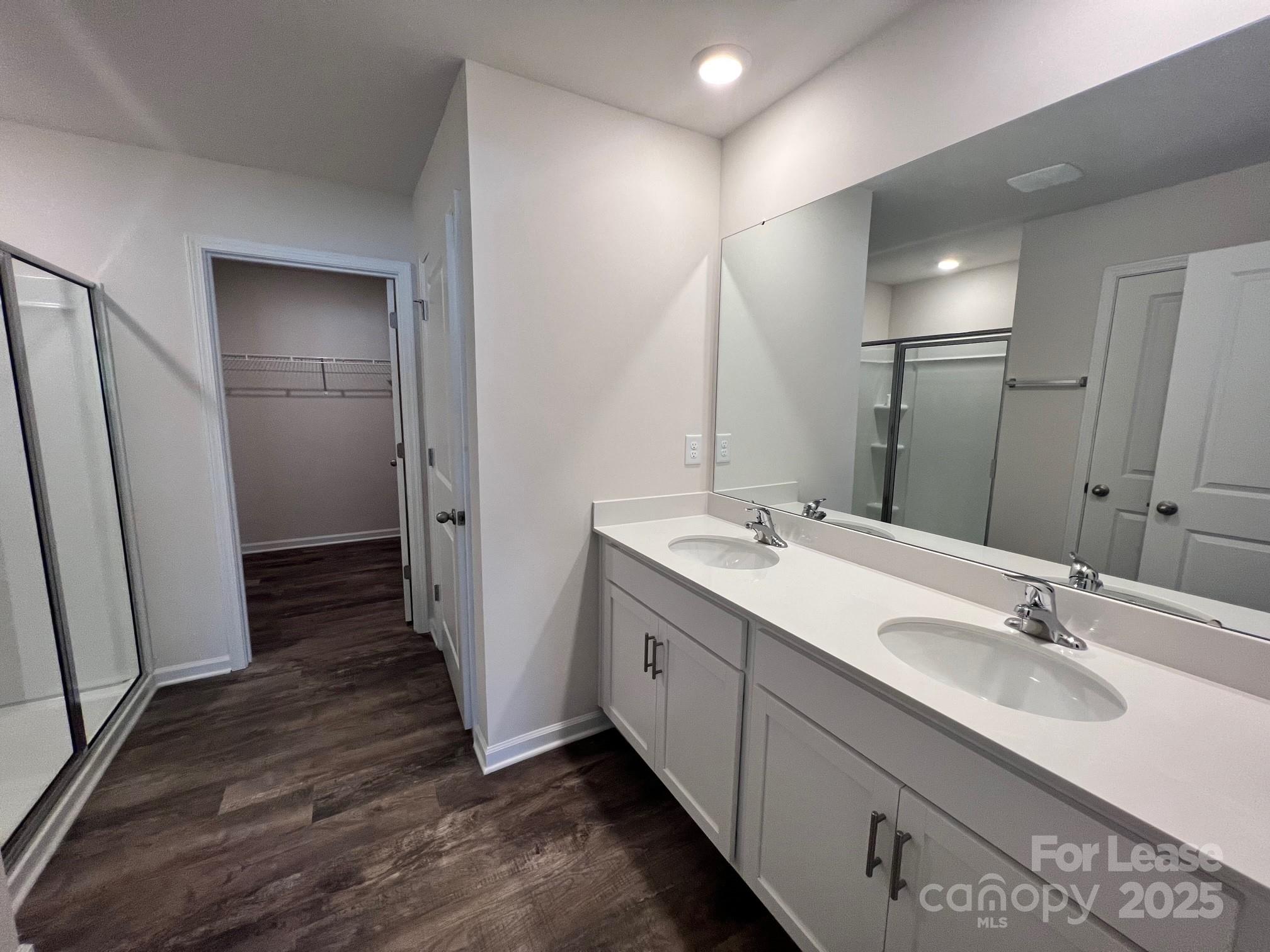 7868 Whispering Stream Drive Sherrills Ford, NC 28673 - Photo 25 of 35 a bathroom with a double vanity sink and mirror