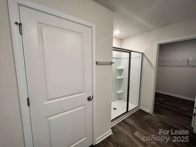 a bathroom with a glass shower door