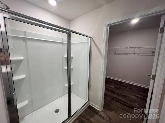a bathroom with a toilet and a shower