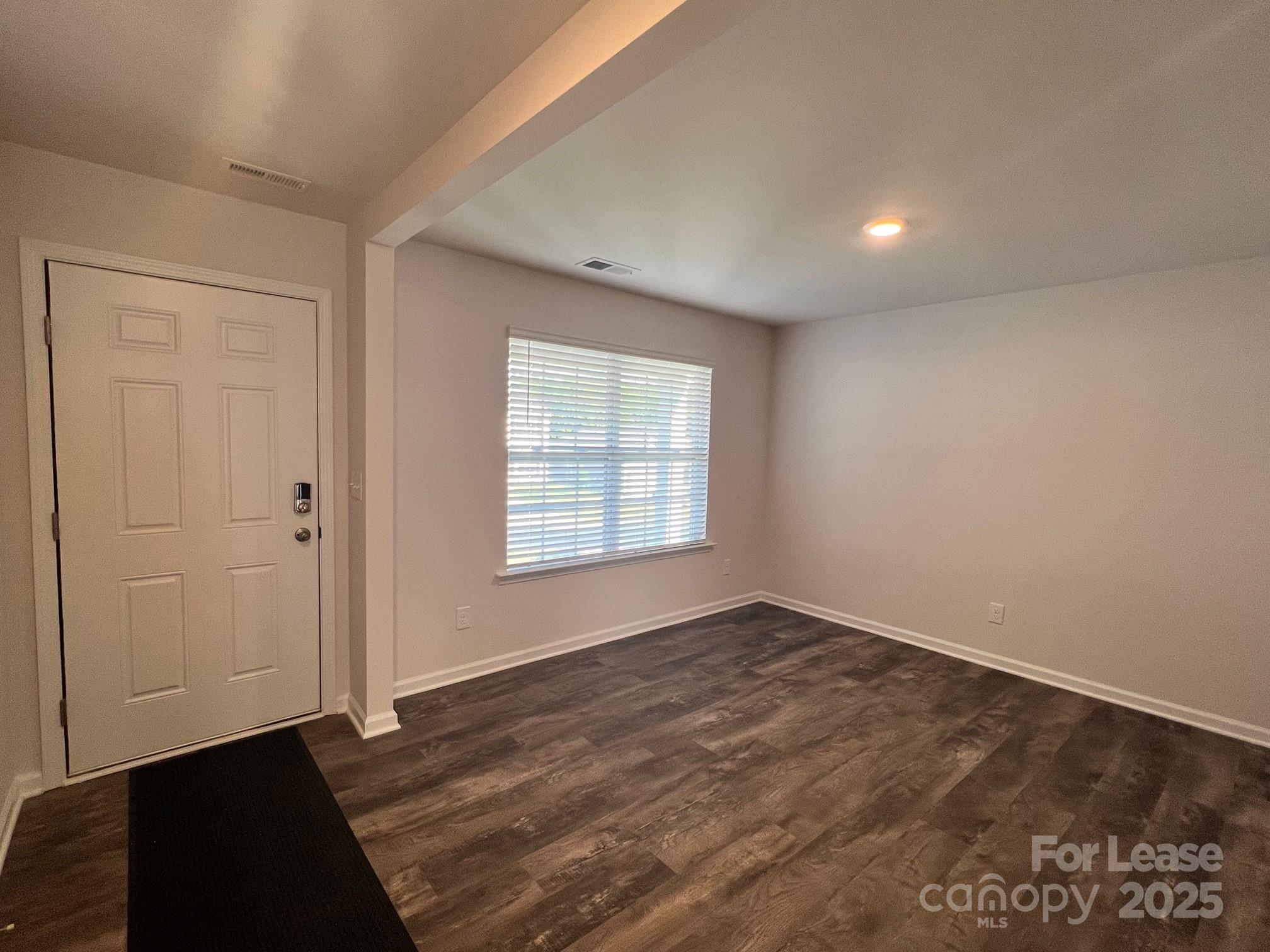 7868 Whispering Stream Drive Sherrills Ford, NC 28673 - Photo 4 of 35 an empty room with wooden floor and windows