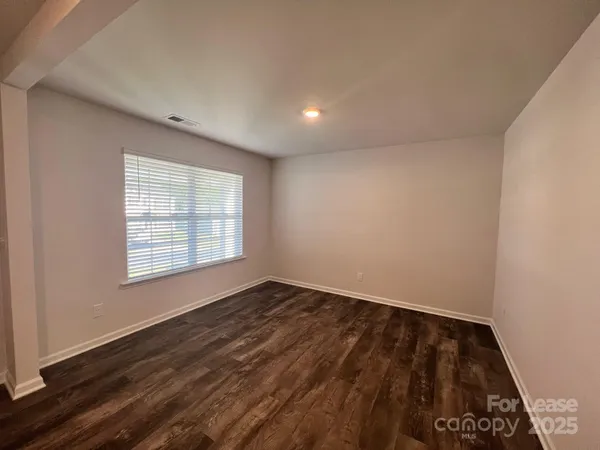 a view of an empty room and a window
