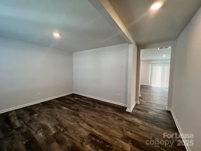 en empty room with wooden floor