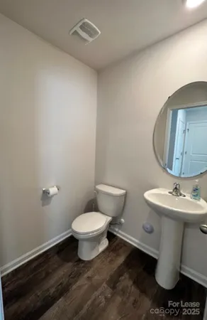 a white toilet sitting next to a bathroom sink