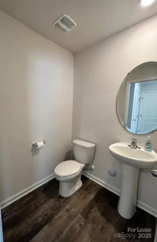a white toilet sitting next to a bathroom sink