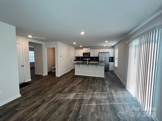a view of kitchen with refrigerator and window