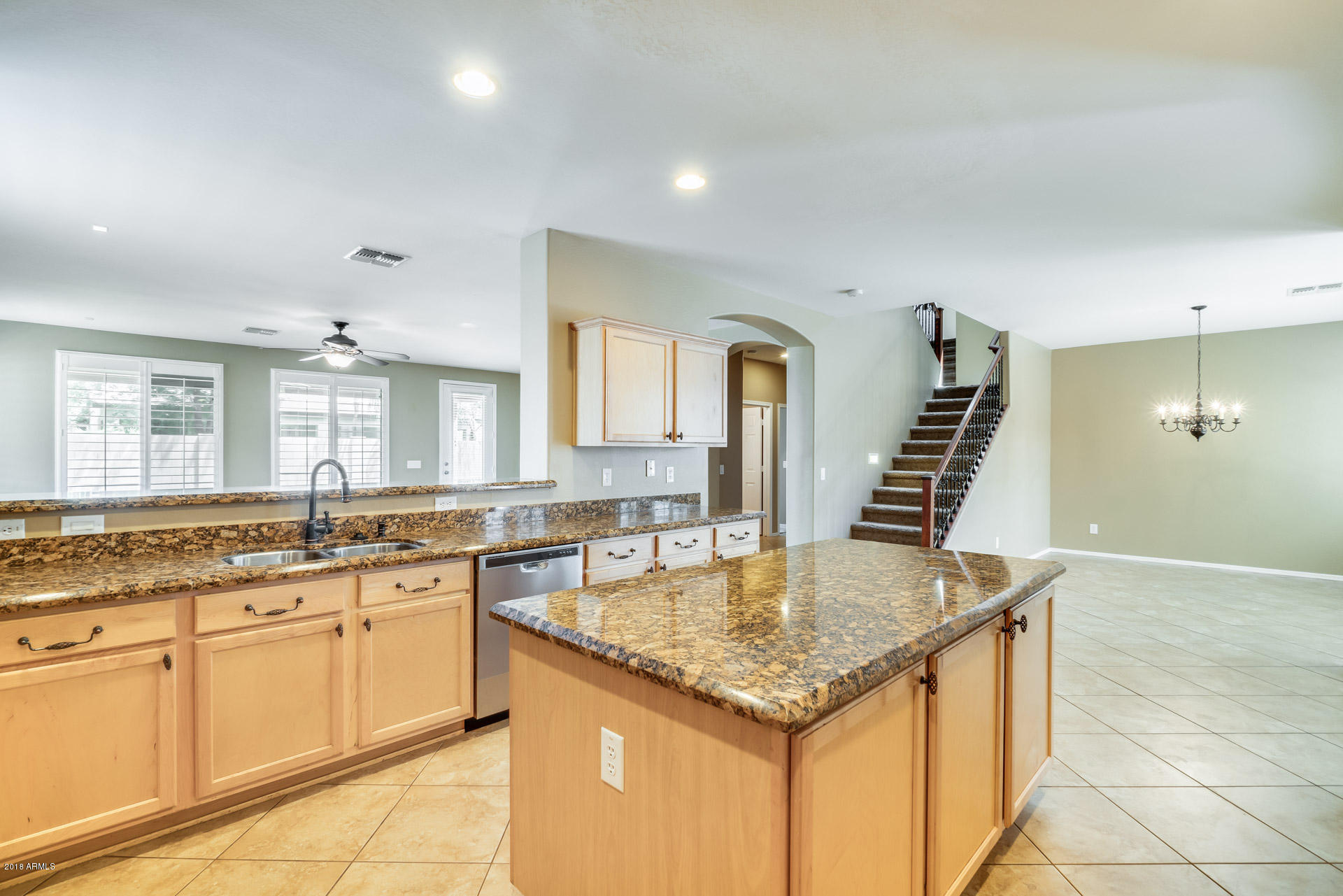 3250 East Blue Ridge Way Gilbert, AZ 85298 - Photo 4 of 44 a kitchen with a stove a sink and a refrigerator