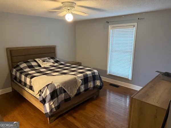 a bed sitting in a bedroom next to a window