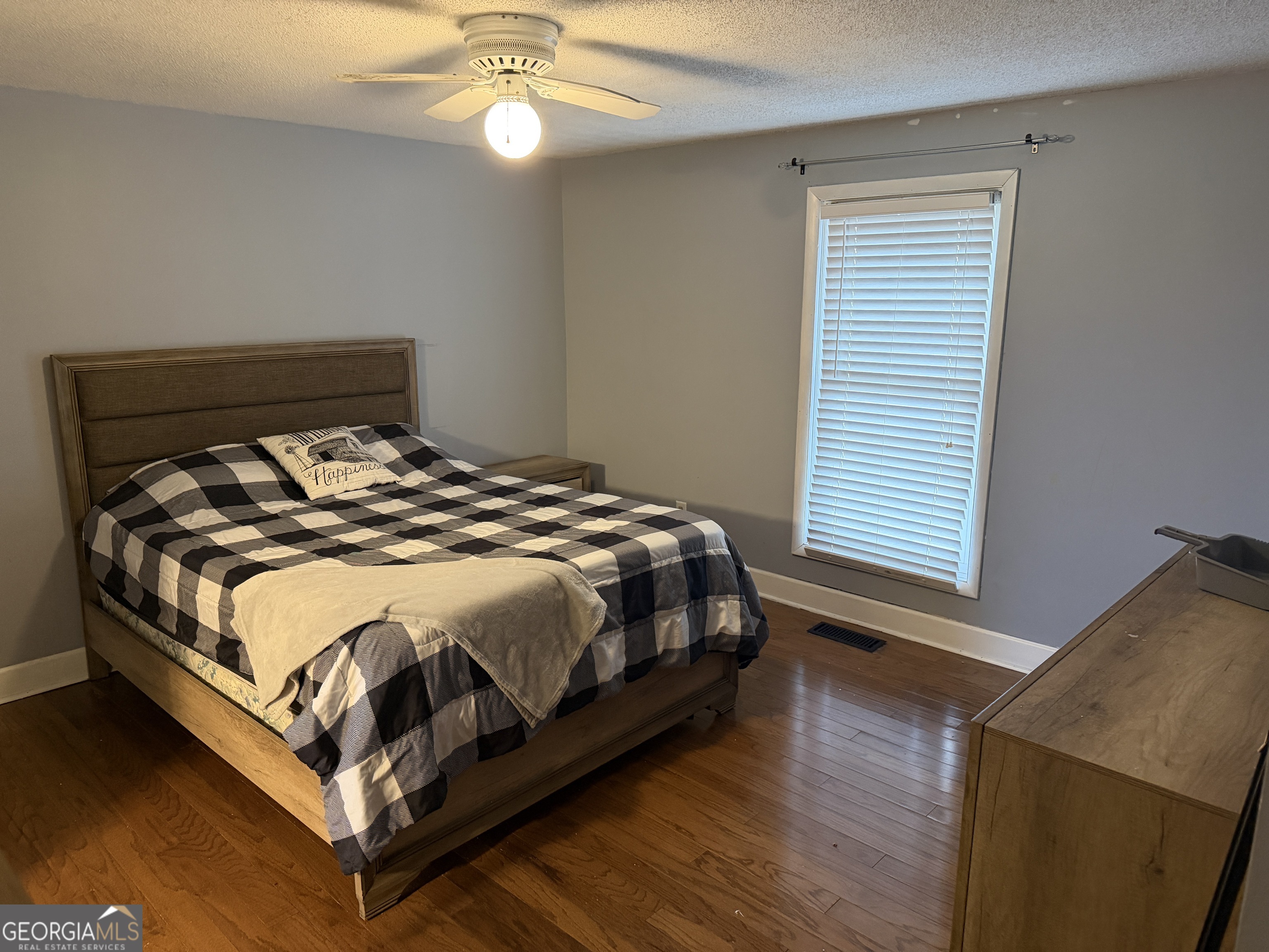 141 Evergreen Church Road Cobbtown, GA 30420 - Photo 10 of 29 a bed sitting in a bedroom next to a window