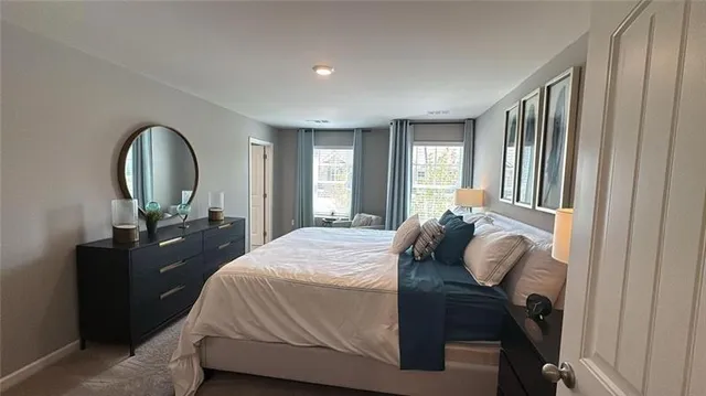 a bedroom with a bed and a mirror on dresser