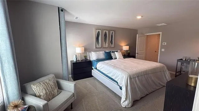 a bedroom with a bed and couch