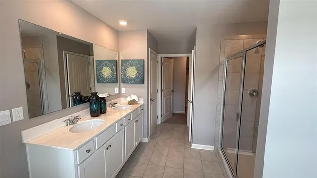 a large bathroom with a double vanity sink and mirror