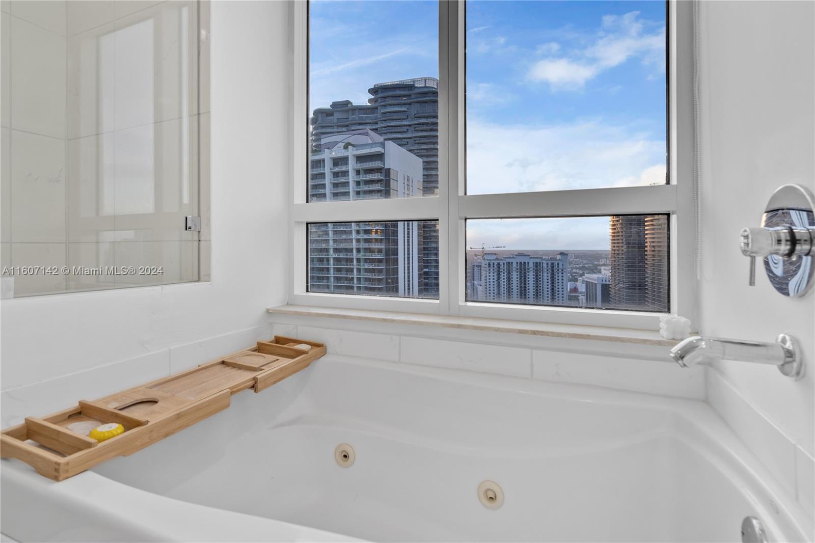 951 Brickell Avenue, Unit PH4111 Miami, FL 33131 - Photo 11 of 32 a bath tub sitting next to a window