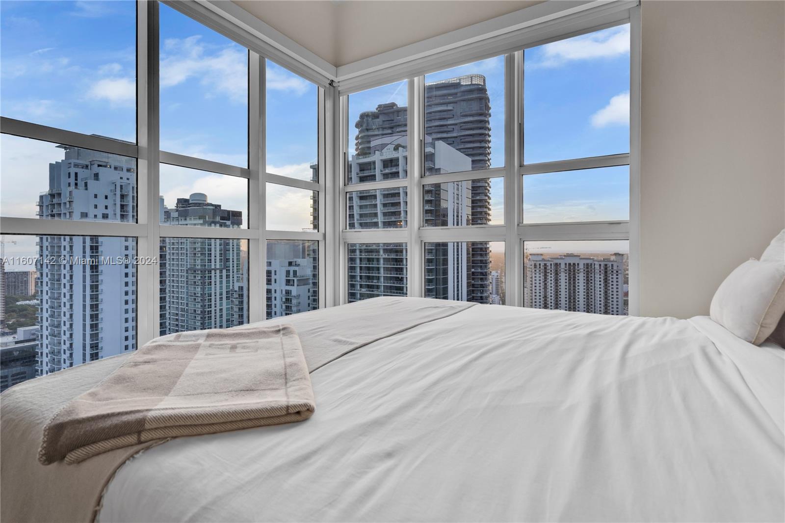 951 Brickell Avenue, Unit PH4111 Miami, FL 33131 - Photo 12 of 32 a bedroom with a large bed and a large window