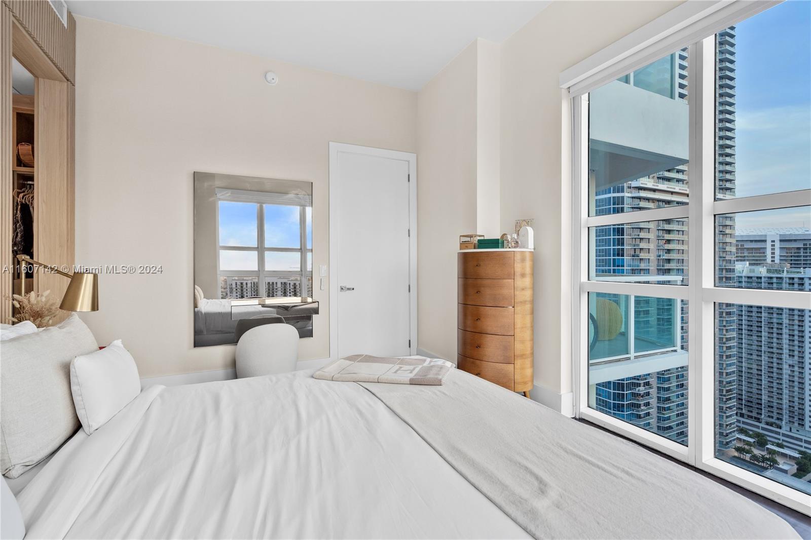951 Brickell Avenue, Unit PH4111 Miami, FL 33131 - Photo 14 of 32 a bedroom with a large bed and a large window