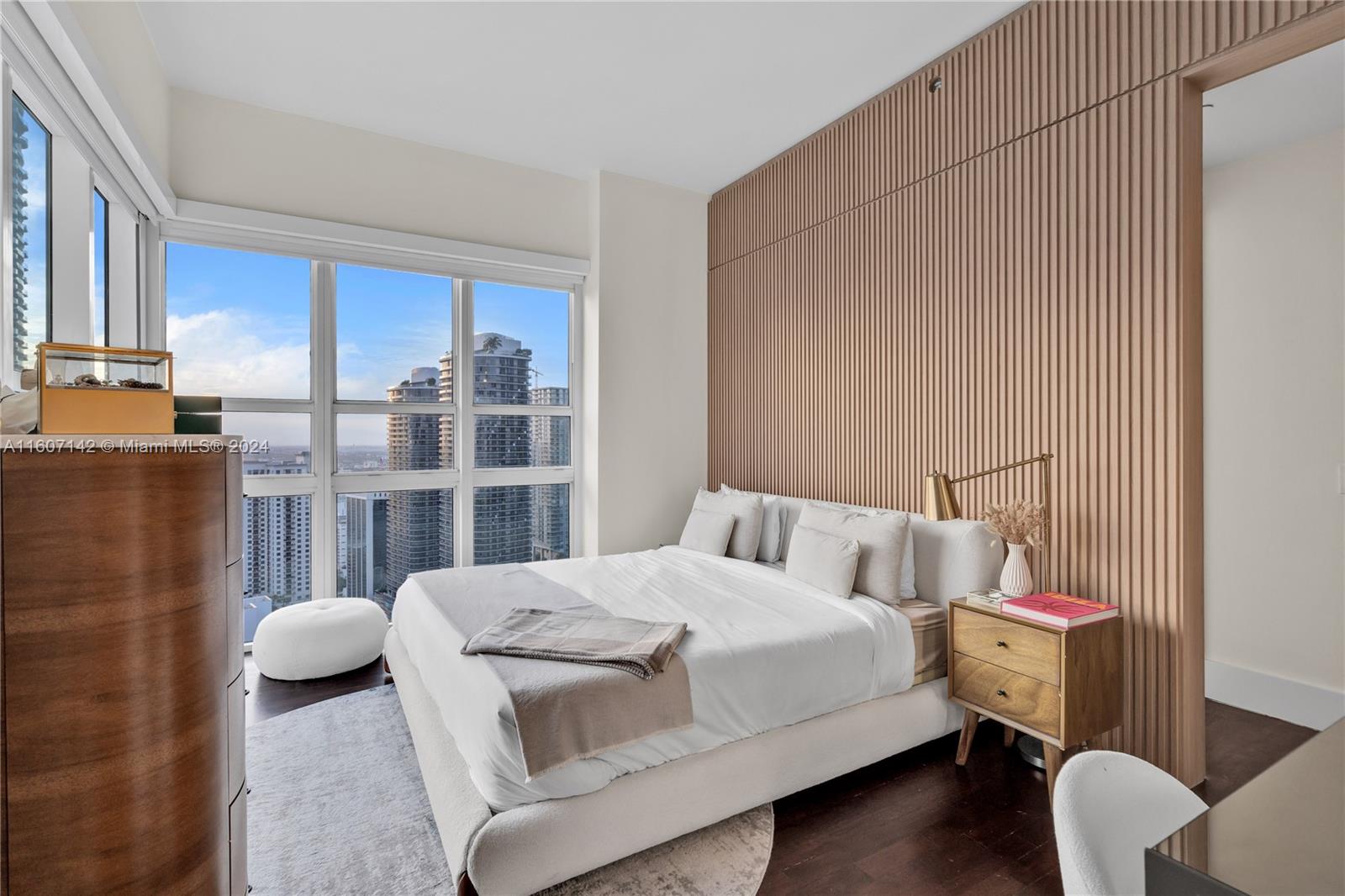 951 Brickell Avenue, Unit PH4111 Miami, FL 33131 - Photo 15 of 32 a bedroom with a bed and a dresser