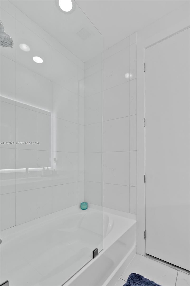 951 Brickell Avenue, Unit PH4111 Miami, FL 33131 - Photo 16 of 32 a bathroom with a bathtub and a shower