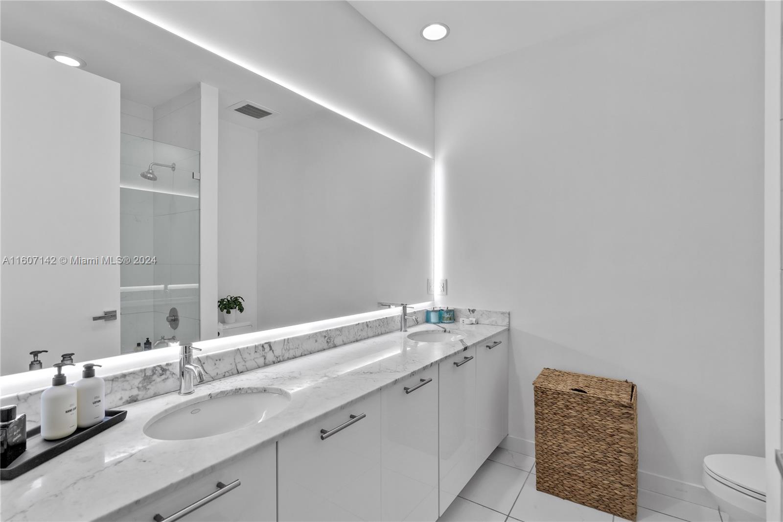 951 Brickell Avenue, Unit PH4111 Miami, FL 33131 - Photo 17 of 32 a bathroom with a granite countertop sink and a mirror