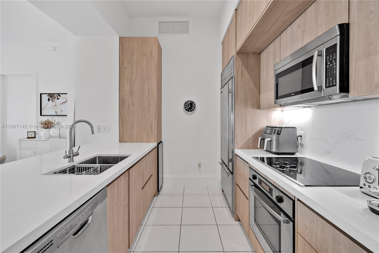 951 Brickell Avenue, Unit PH4111 Miami, FL 33131 - Photo 23 of 32 a kitchen with stainless steel appliances granite countertop a sink stove and cabinets