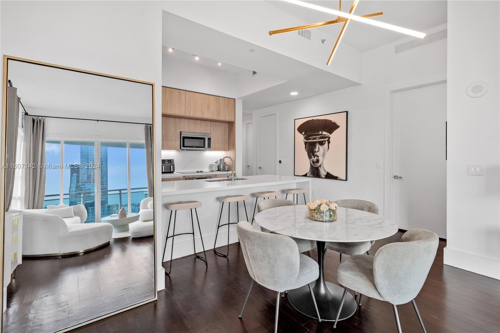 951 Brickell Avenue, Unit PH4111 Miami, FL 33131 - Photo 24 of 32 a view of a dining room with furniture and wooden floor