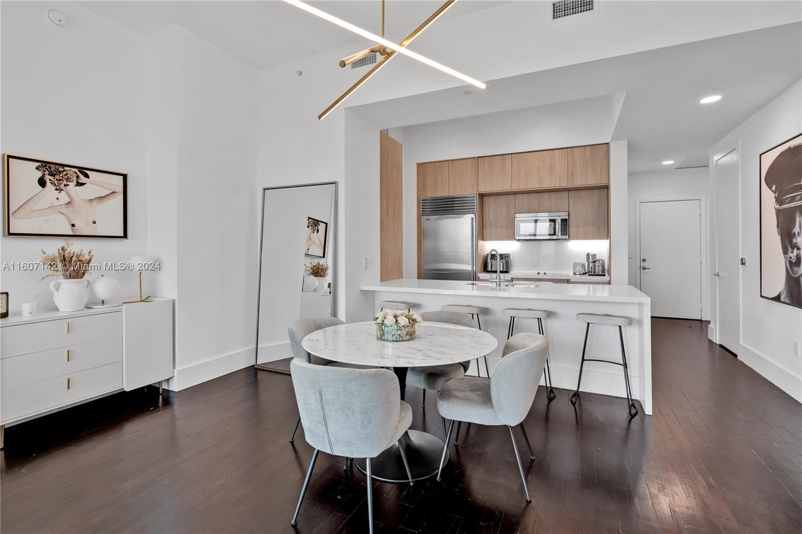 951 Brickell Avenue, Unit PH4111 Miami, FL 33131 - Photo 25 of 32 a view of a dining room with furniture and wooden floor