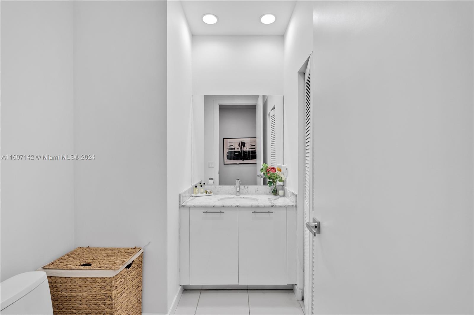 951 Brickell Avenue, Unit PH4111 Miami, FL 33131 - Photo 26 of 32 a bathroom with a sink and a mirror