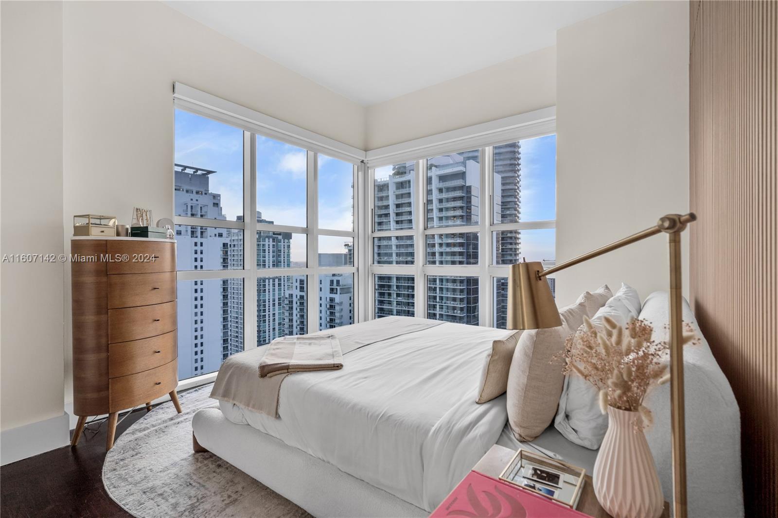 951 Brickell Avenue, Unit PH4111 Miami, FL 33131 - Photo 3 of 32 a bedroom with a large bed and a wooden floor