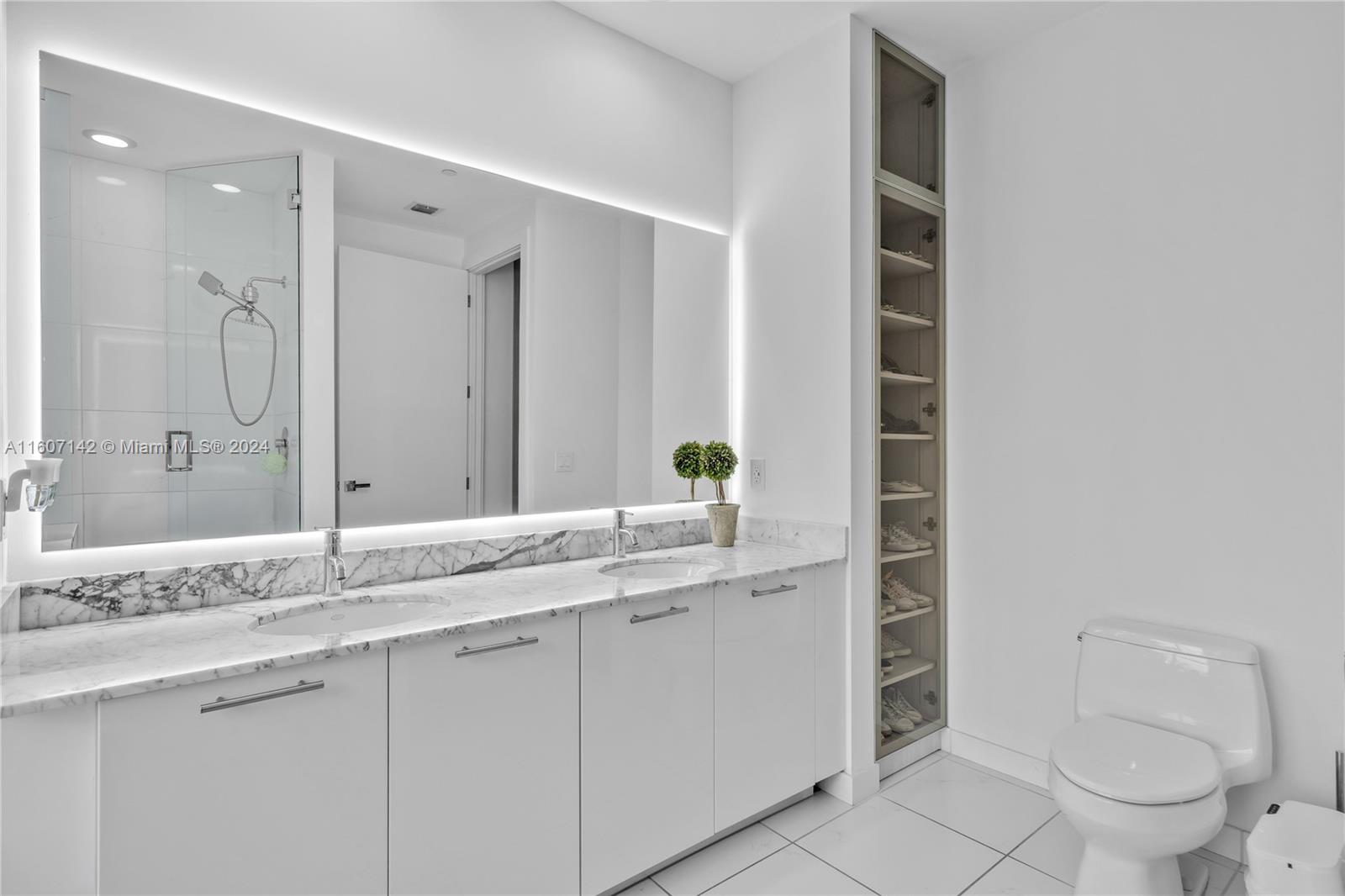 951 Brickell Avenue, Unit PH4111 Miami, FL 33131 - Photo 9 of 32 a bathroom with a granite countertop sink toilet and shower