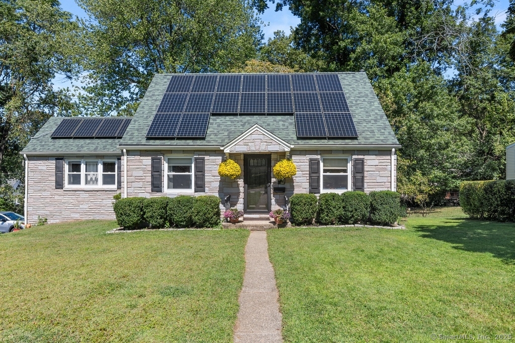 a front view of a house with garden