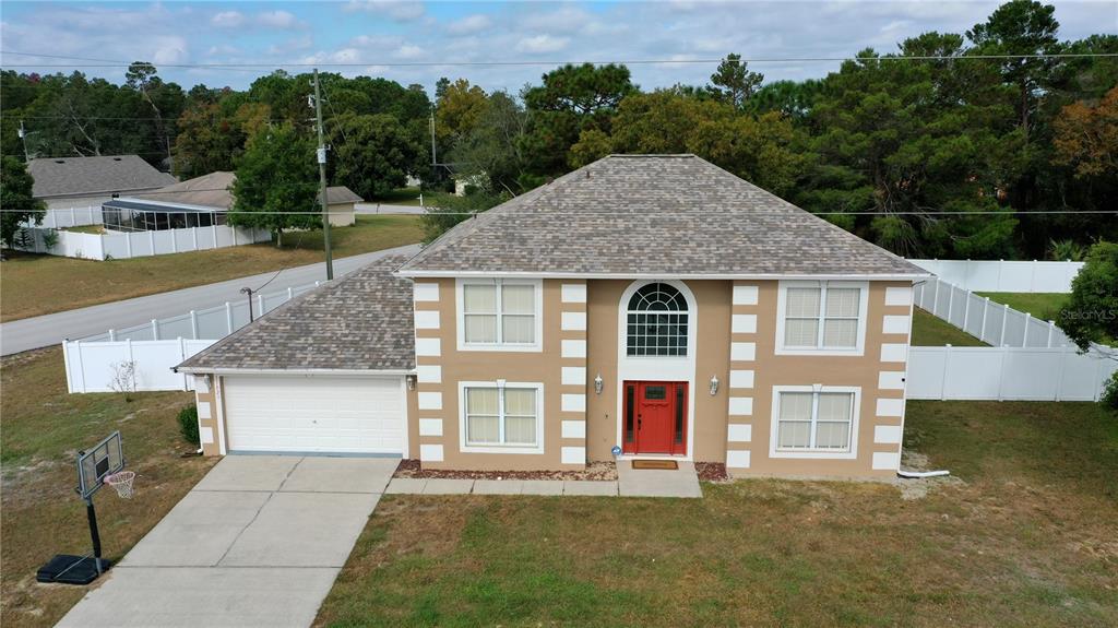 11023 Norvell Road Spring Hill, FL 34608 - Photo 1 of 1 a front view of a house with a yard