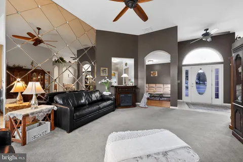 a living room with furniture and a chandelier