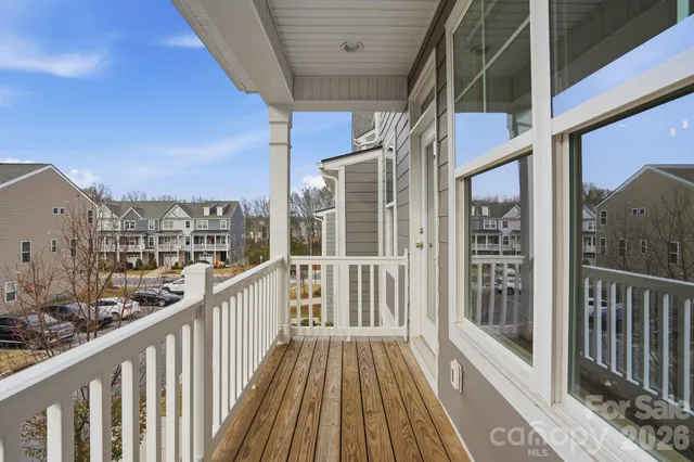 a view of a balcony with wooden floor