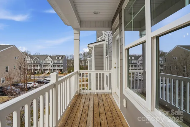 a view of a balcony with wooden floor
