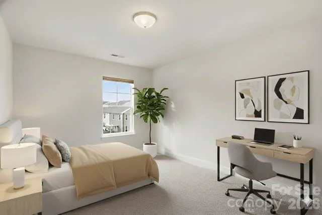 a bedroom with a bed and paintings on the wall